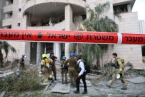 Responders inspect a damaged building following a strike by an Iranian missile in the Israeli city of Petah Tikva, east of Tel Aviv, on Monday. Jack Guez/AFP/Getty Images